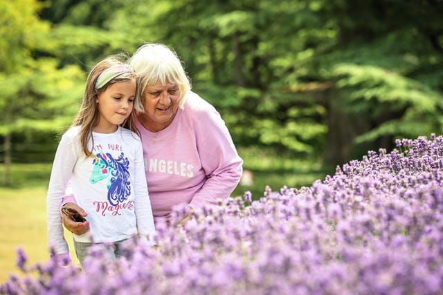 An older woman and a child looking at some plants